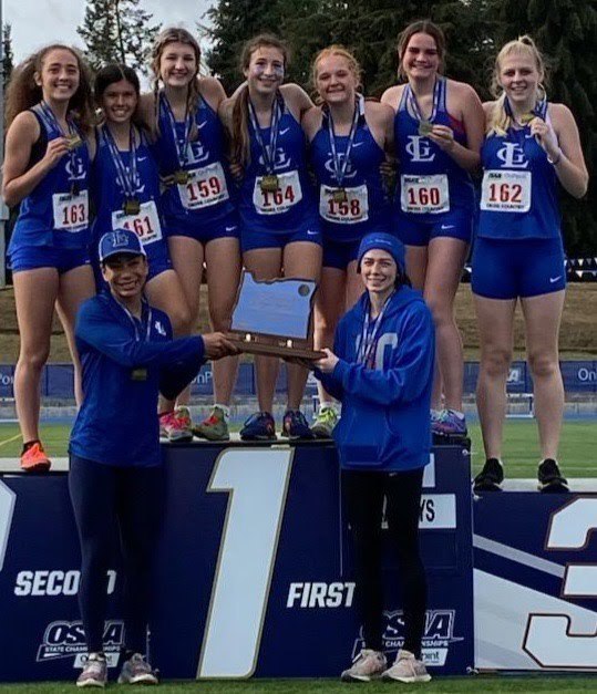 LHS Cross Country Girls team at podium taking first place