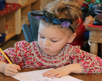 Small girl writing