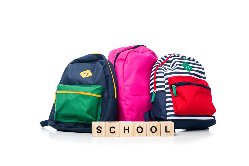 Photo of school and backpacks