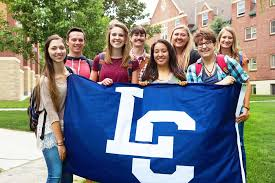 Students holding the lewis-clark college flag