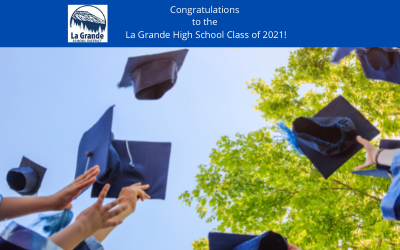 Graduation caps flying in the air.  "Congratulations to the La Grande High School Class of 2021!"