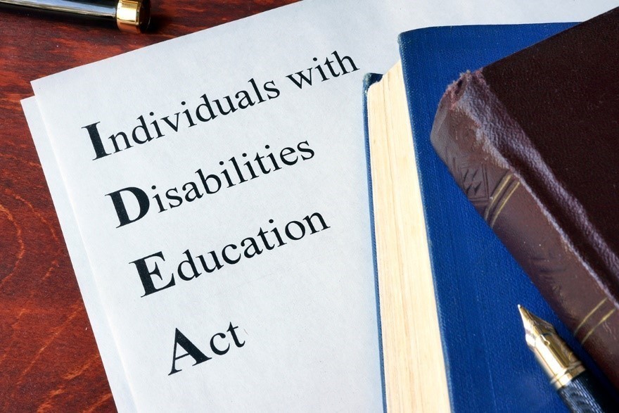 paper and books with Individuals with Disabilities Education Act printed on the paper
