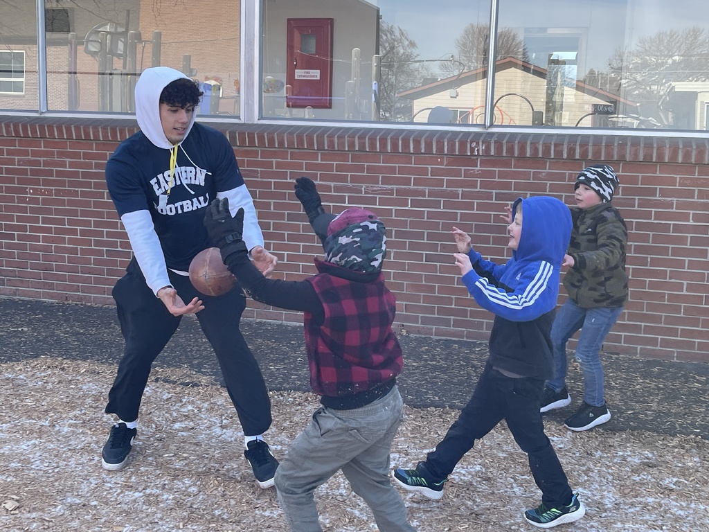 students playing outside with an EOU student athlete