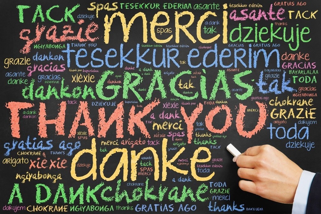 chalkboard with Thank you written in different colors and languages